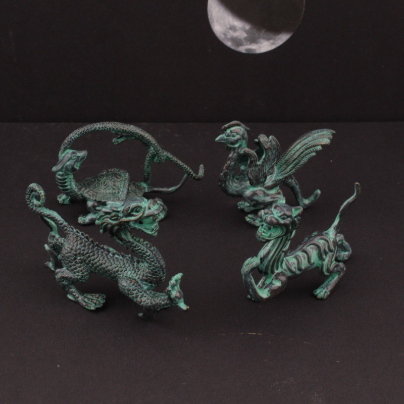 A set of bronze artifacts featuring the four mythical beasts