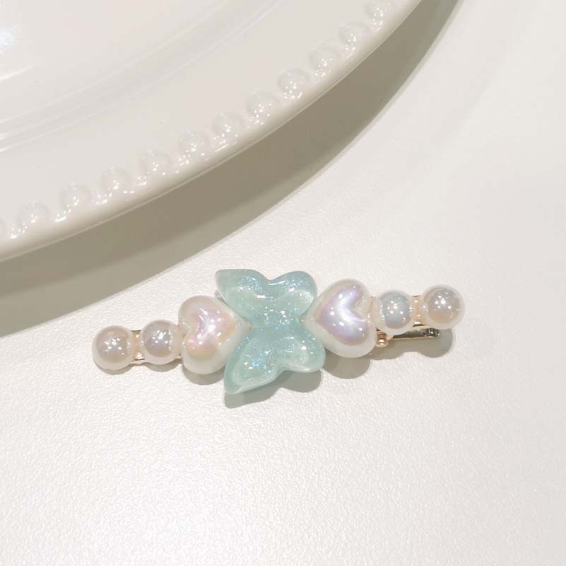 Papillon bleu ciel uni avec perles.