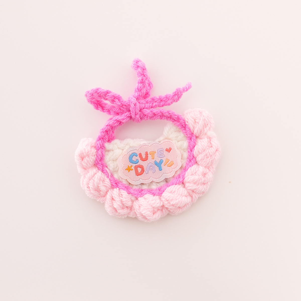 Bib with white background, pink trim, and pink lettering