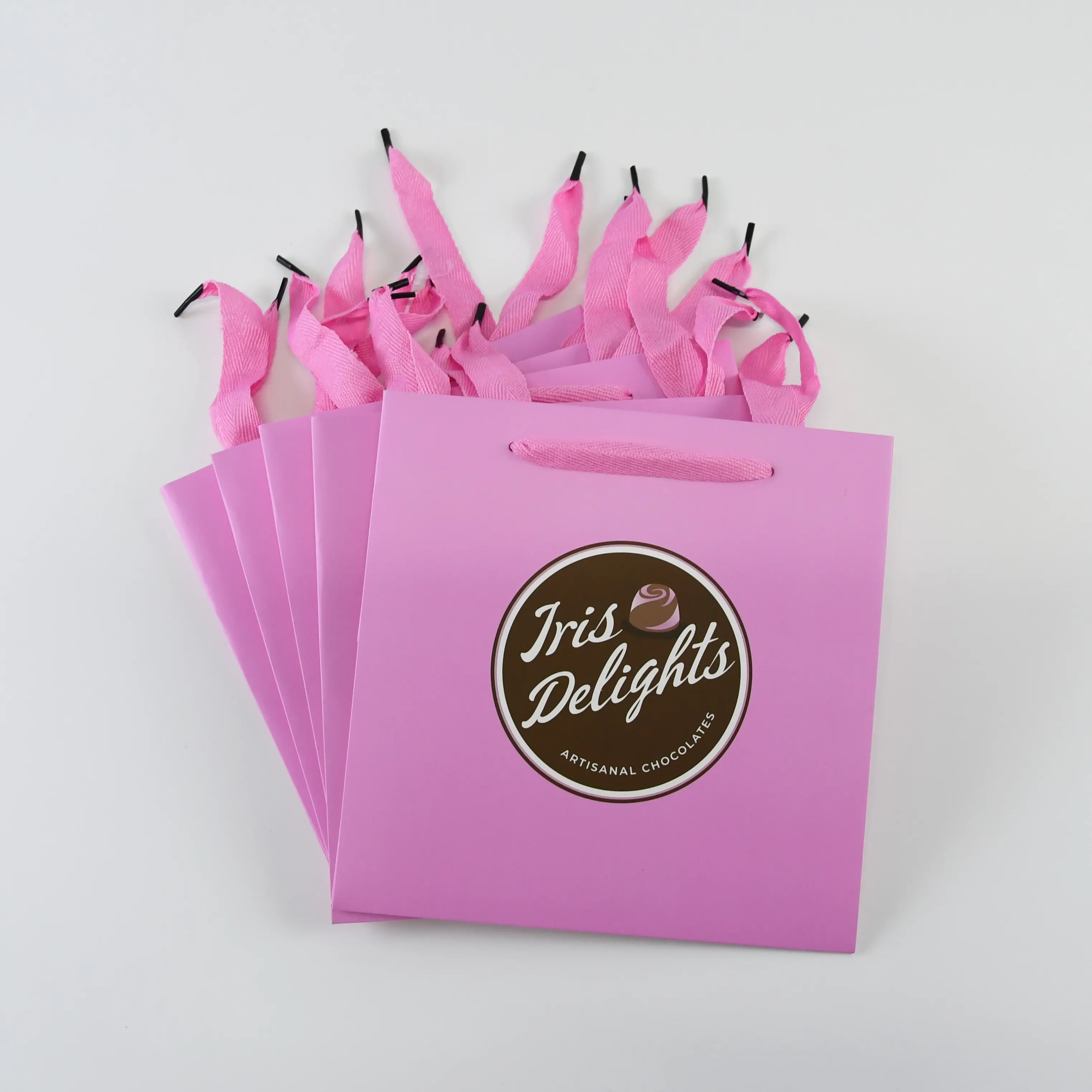 Precio de fábrica logotipo personalizado impreso Rosa bolsa de papel de embalaje con asa y cinta bolsa de compras de regalo