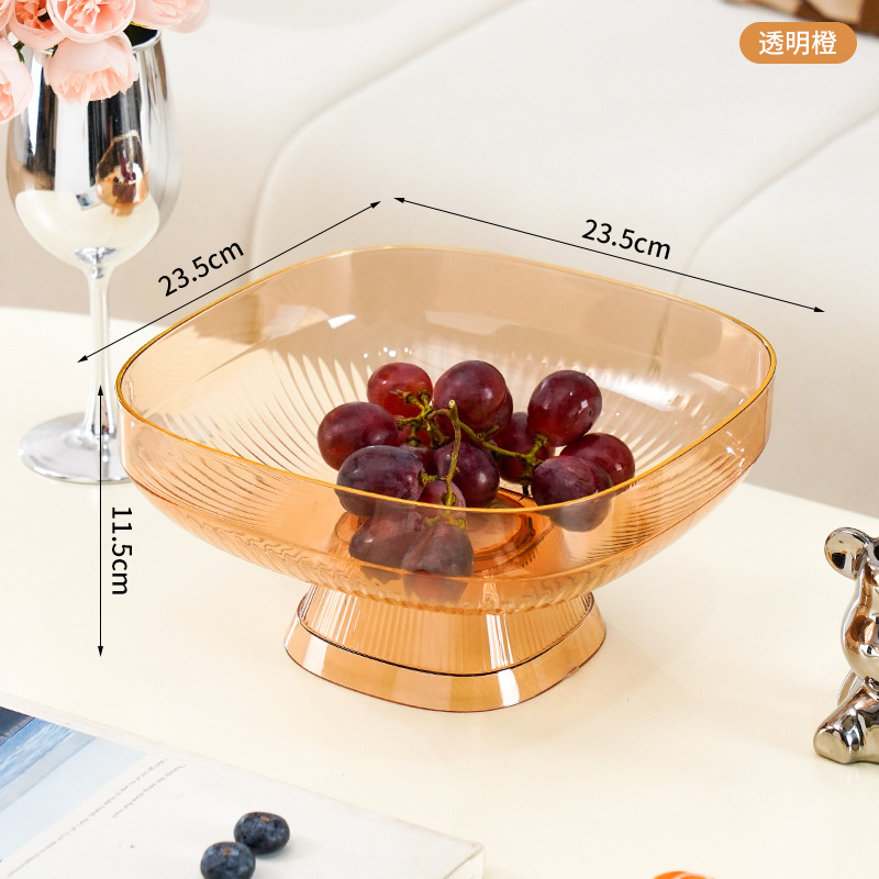 A tall, elegant fruit platter featuring transparent oranges.