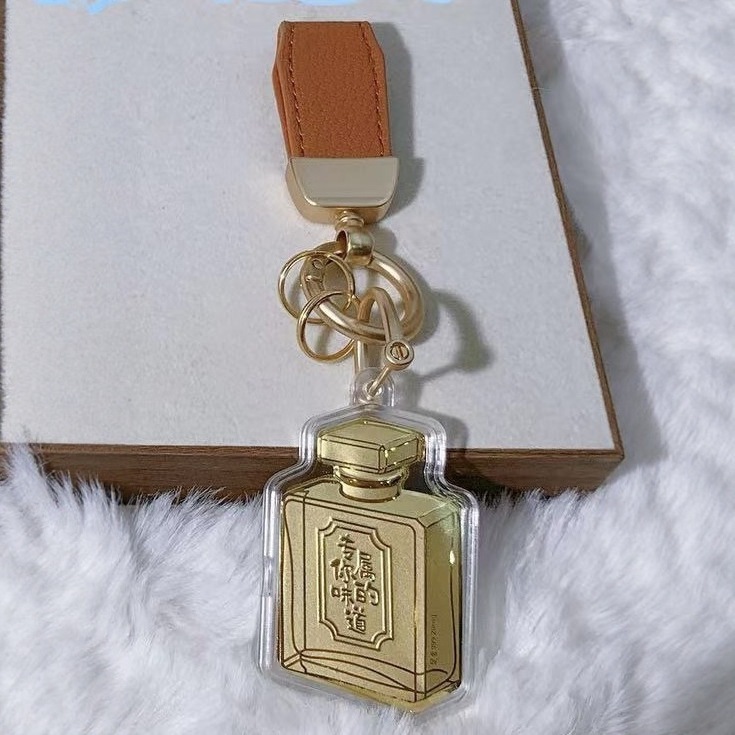 Flacon de parfum (contenant 20mg d'or - cordon orange)