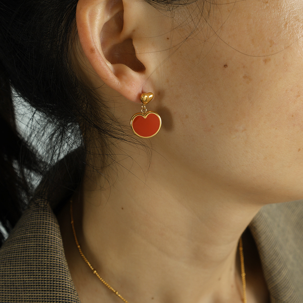 Une paire de boucles d'oreilles EH21 dorées et rouges