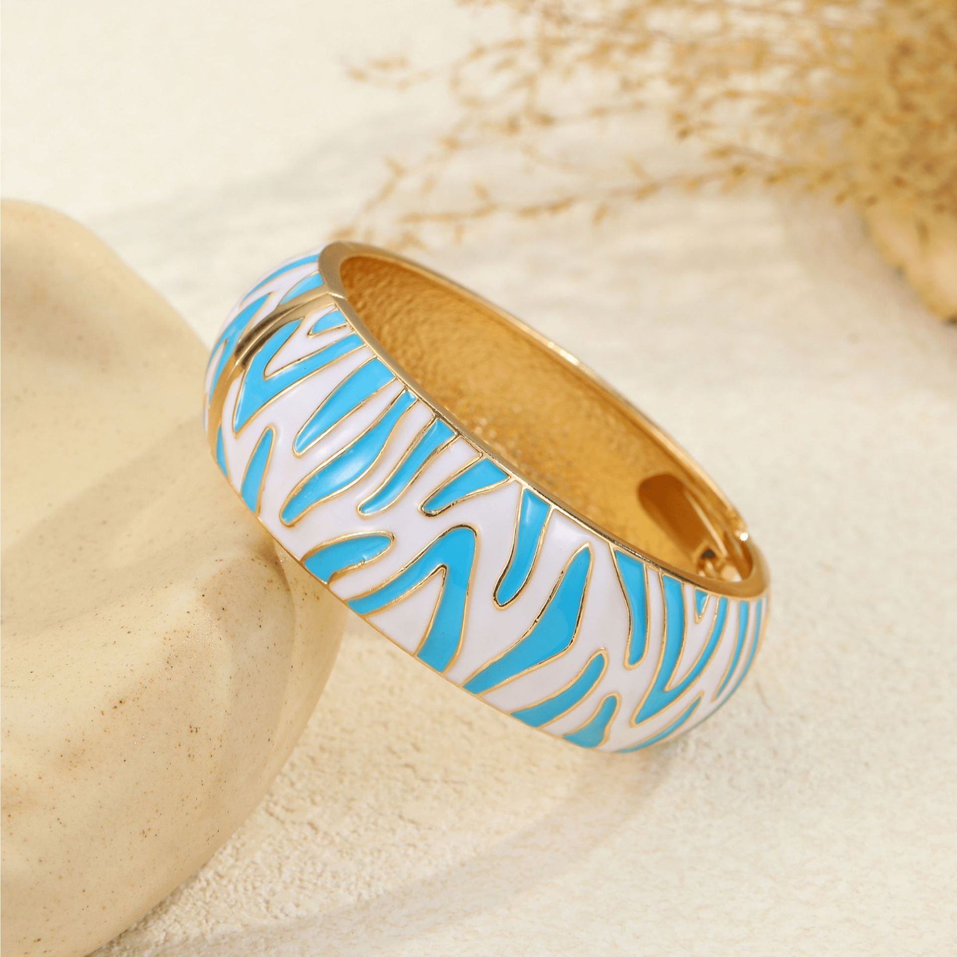 Base blanca chapada en oro con patrón de cebra azul zafiro.