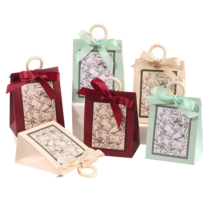 Bolsa de papel con asa para mujer estilo moda al por mayor con cinta para caja de regalo de papel de caramelo