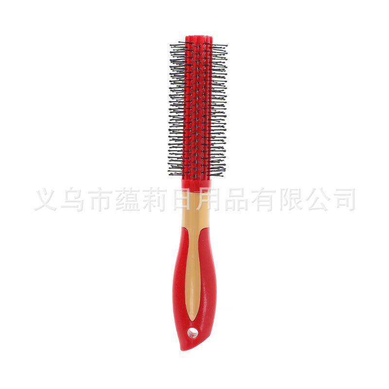 Red curling comb with gold center ring