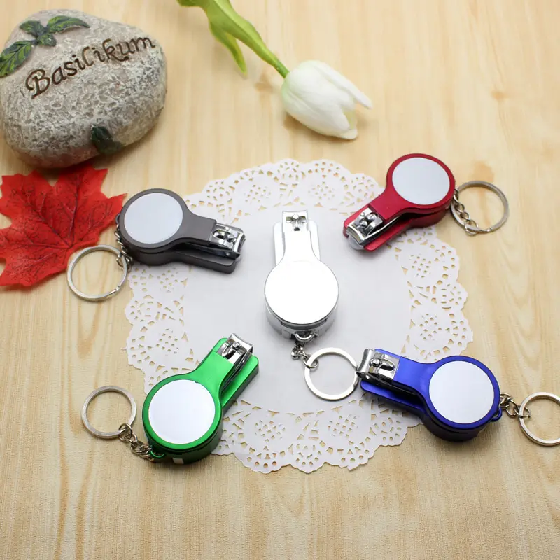 Vente en gros de porte-clés coupe-ongles trois en un en métal avec stylo à bille Porte-clés en métal avec logo personnalisé pour cadeaux promotionnels