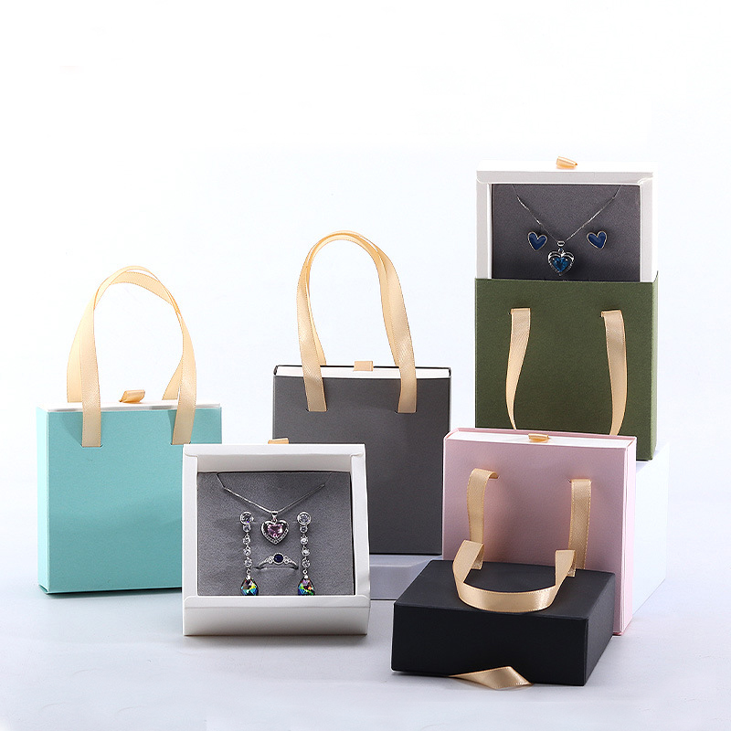 Caja plegable para joyería con asa.