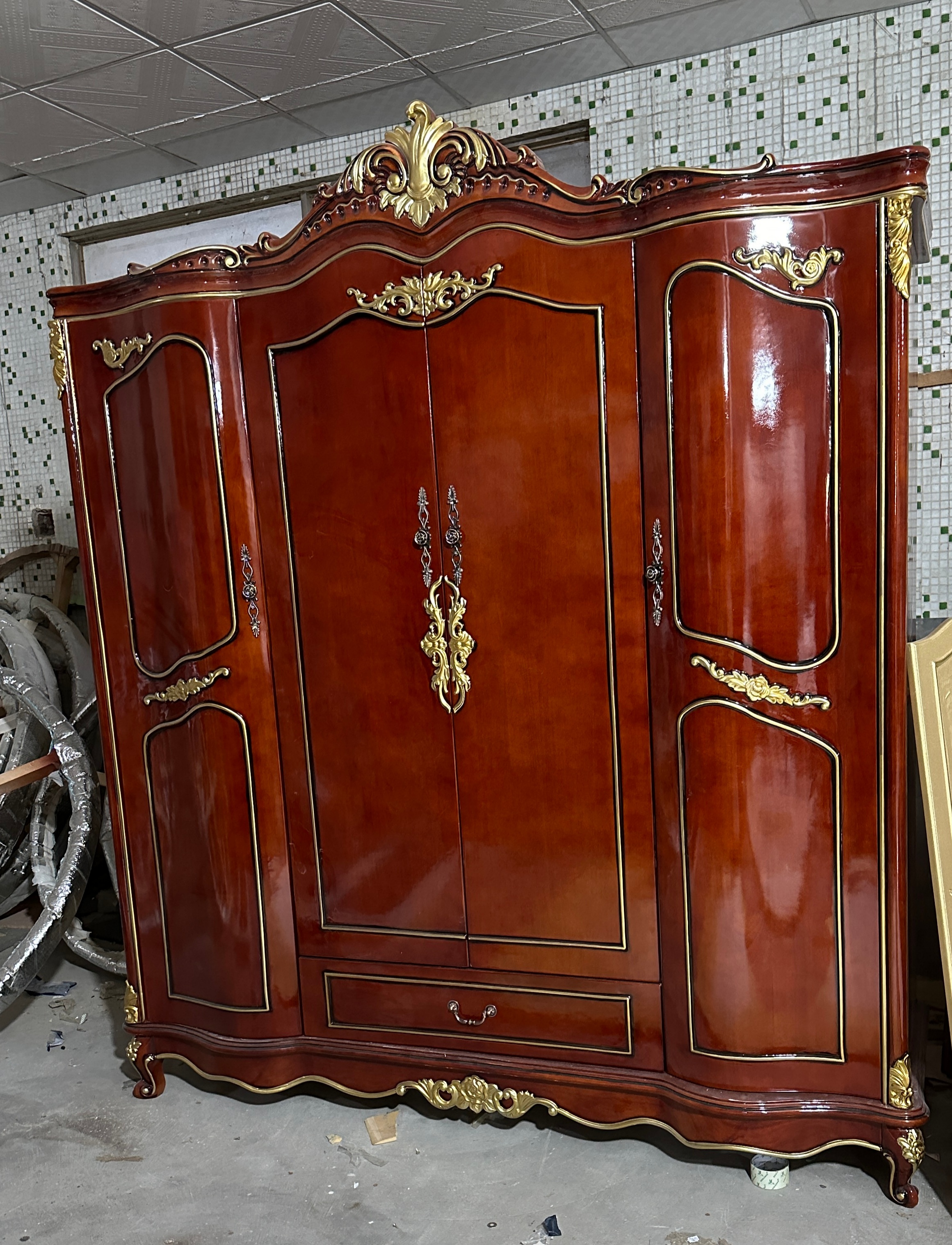 A four-door wardrobe painted in black and gold.