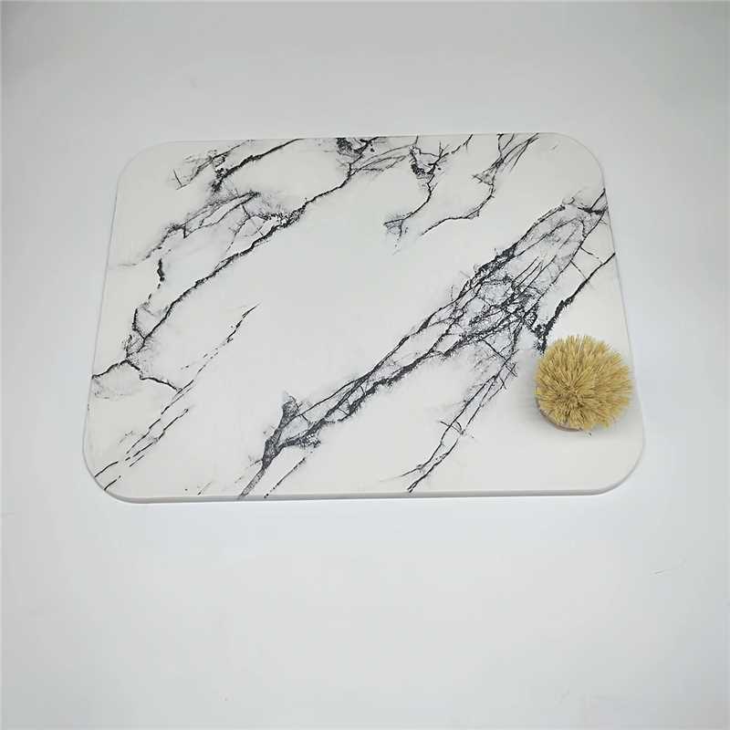 White marble mat with a bamboo brush