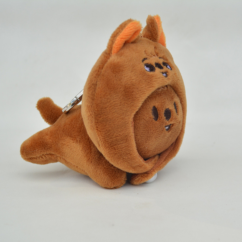 brown bear cap-wearing prone keychain
