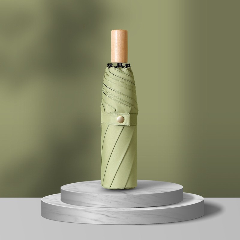 Paraguas plegable de tres secciones, 8 varillas, pegamento negro, color verde matcha liso.