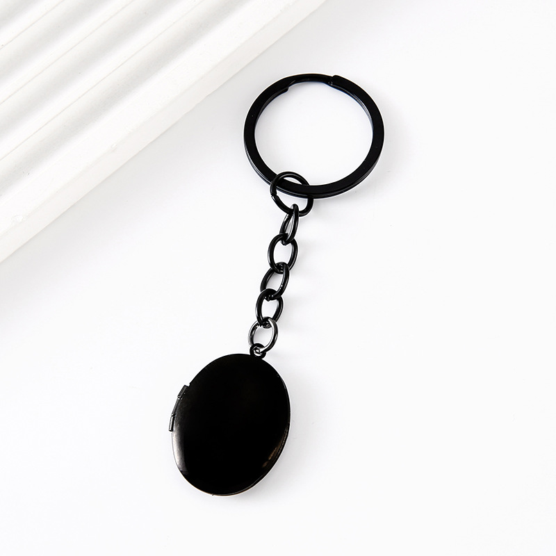 Llavero negro ovalado con estuche para fotos sin texto