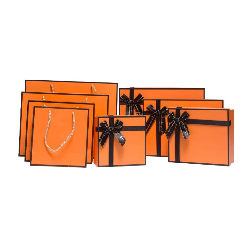 Kotak produk hadiah kustom paket kotak hadiah kardus kosong keras tutup oranye dengan pengisi kertas robek pita hitam