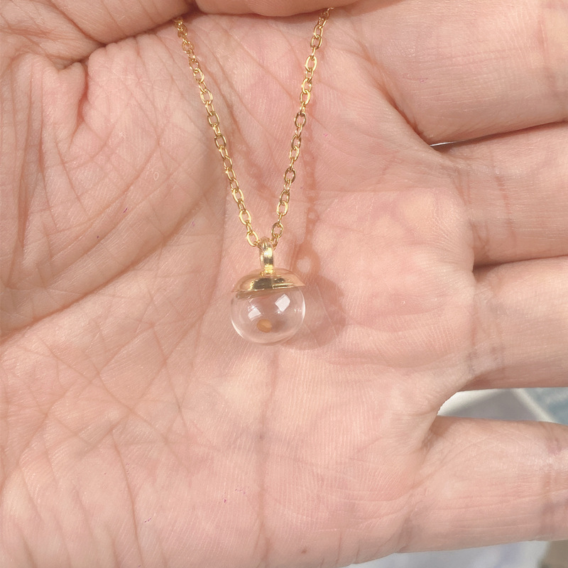 Pendentif bouteille en verre doré