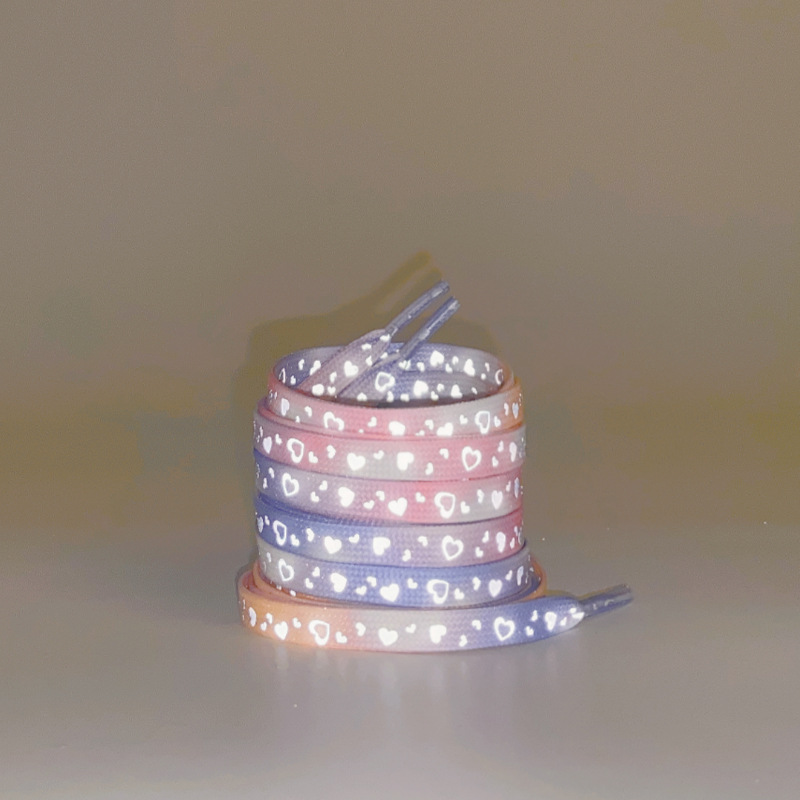 A pair of purple powder reflective love shoelaces