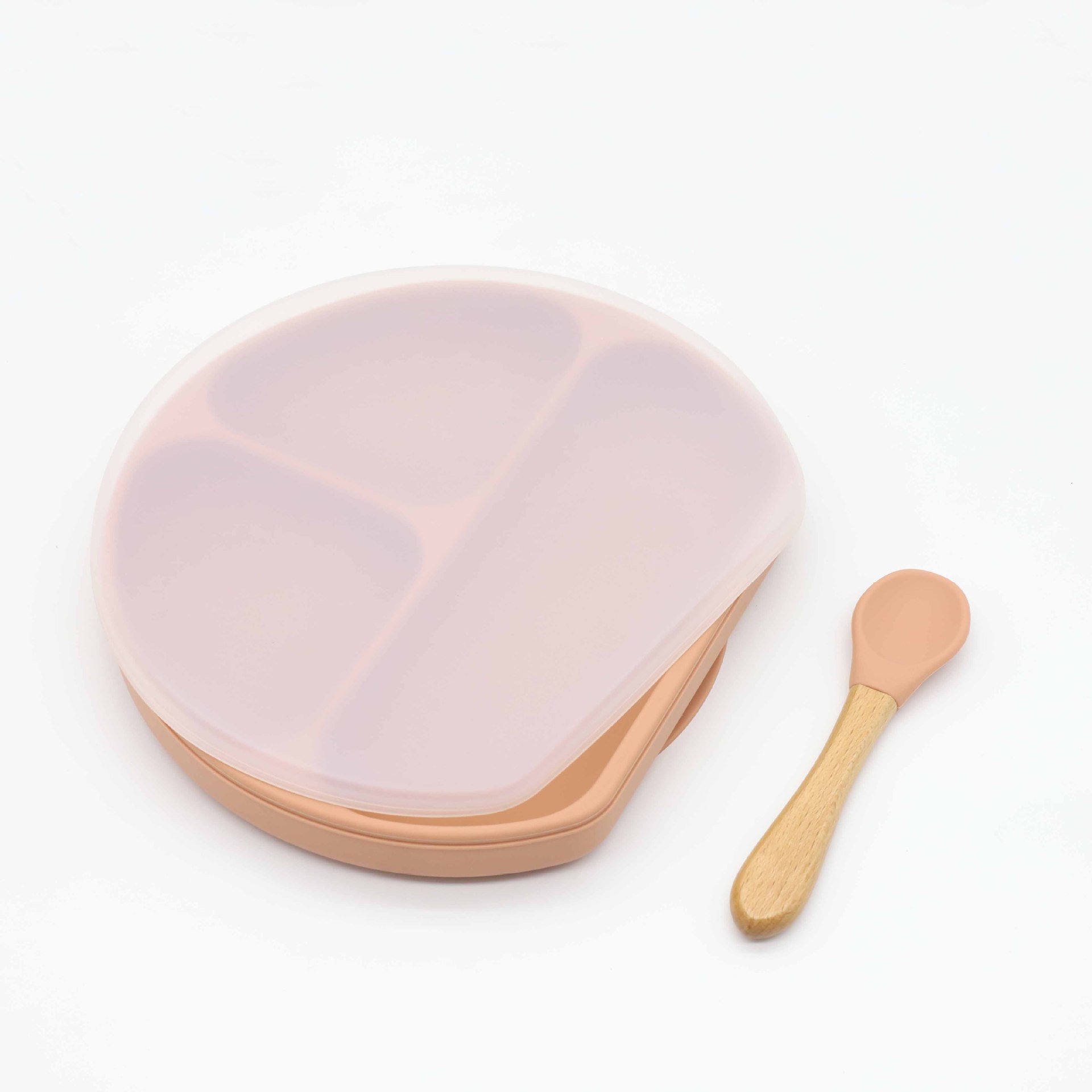 Assiette rouge orangé profond avec couvercle et cuillère.