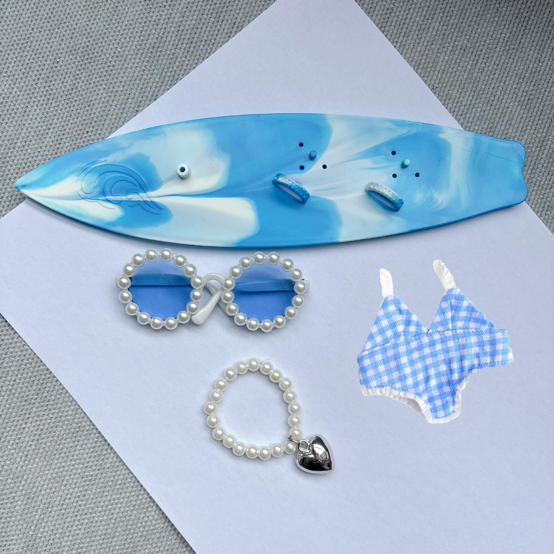 Blue swimsuit blue surfboard necklace blue glasses