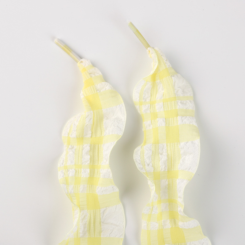 Lacets à carreaux jaune clair