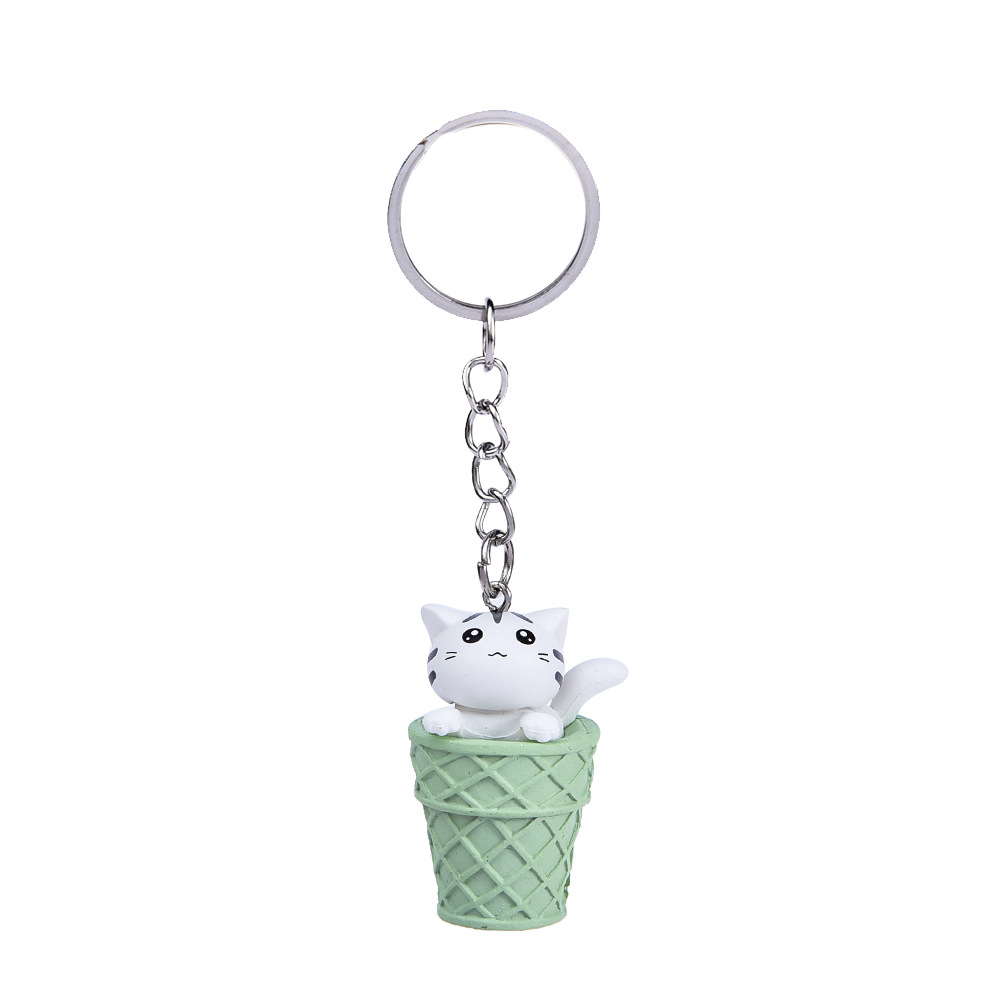 Gato blanco + llavero cubo verde