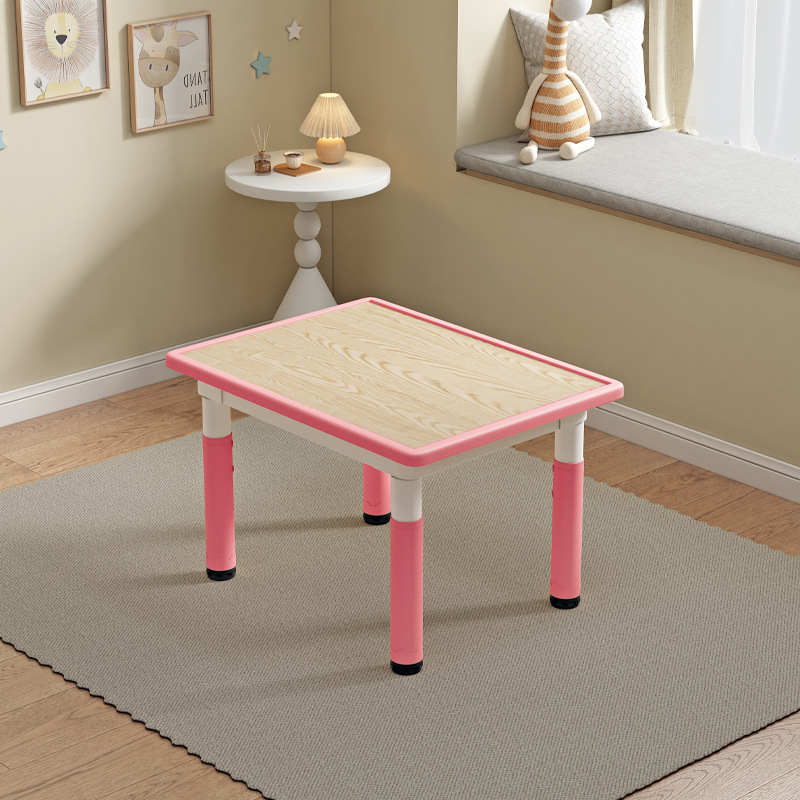 Table individuelle rose clair avec motif de grain de bois.