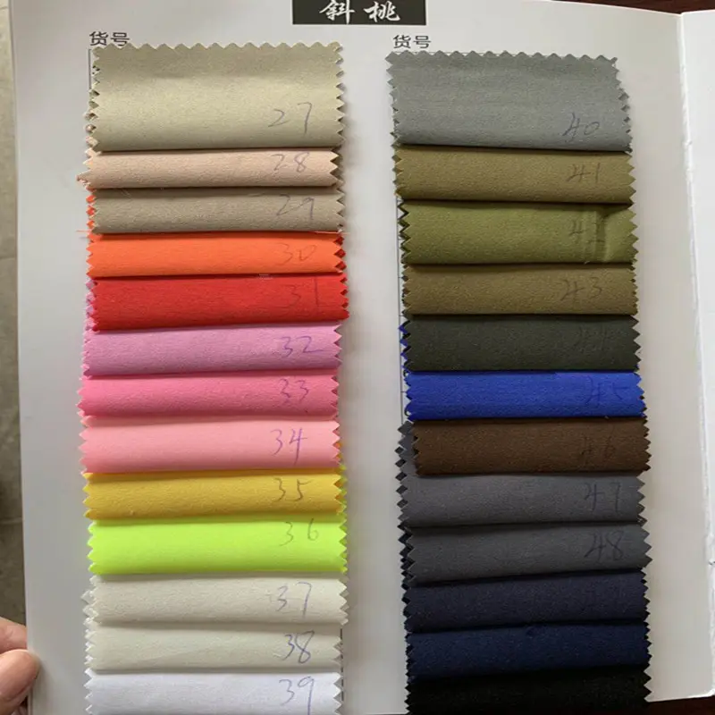 Tela de microfibra lisa, sarga, piel de melocotón, Pongee y Dewspo, 600 colores, productos listos, Closeout y tela de superventas, venta al por mayor