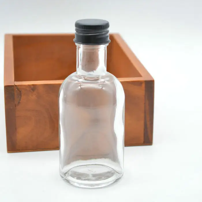 कस्टम 10cl वोदका के लिए शराब कांच की बोतल के साथ 100 ml स्पष्ट दौर बोतल काले पेंच टोपी