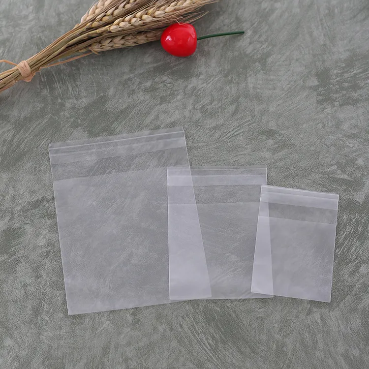 Venta al por mayor de polietileno transparente abierta plana de embalaje de plástico de camiseta bolso Auto adhesivo