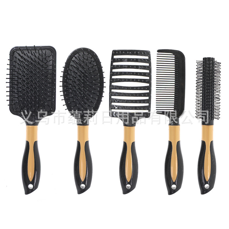 Black openwork hair straightener with gold central ring.