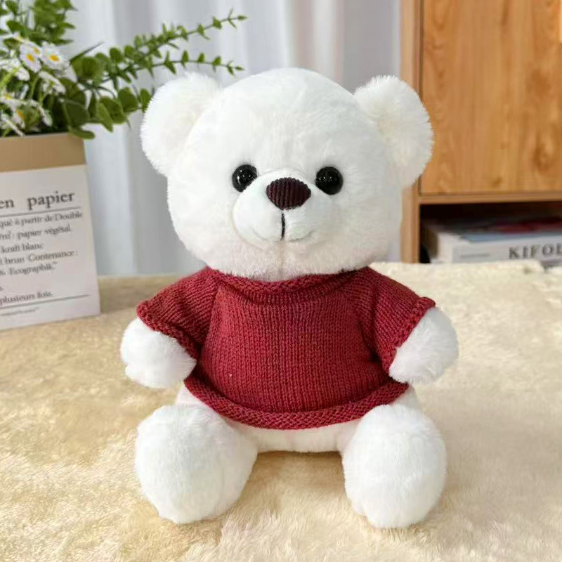 Orsetto di peluche bianco con maglione rosso scuro