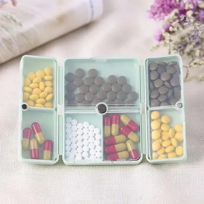 Boîte à pilules hebdomadaire magnétique Portable pliable en plastique Pp à 7 grilles, vente en gros