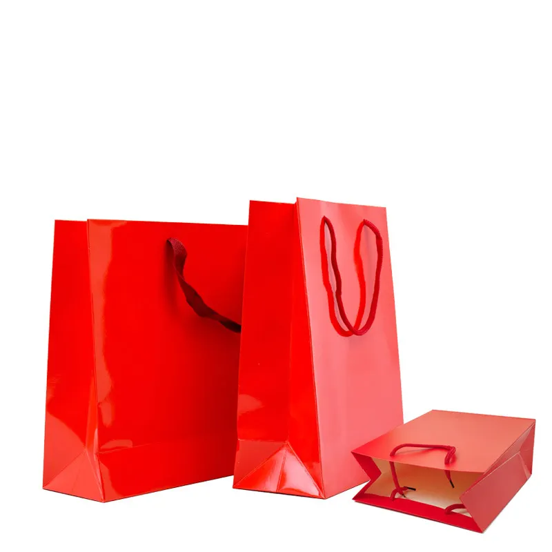 Embalaje de regalo de lujo Estampado en caliente Láser Texto dorado brillante Logotipo personalizado Impreso Cinta Rosa Bolsa de papel de compras para cosméticos