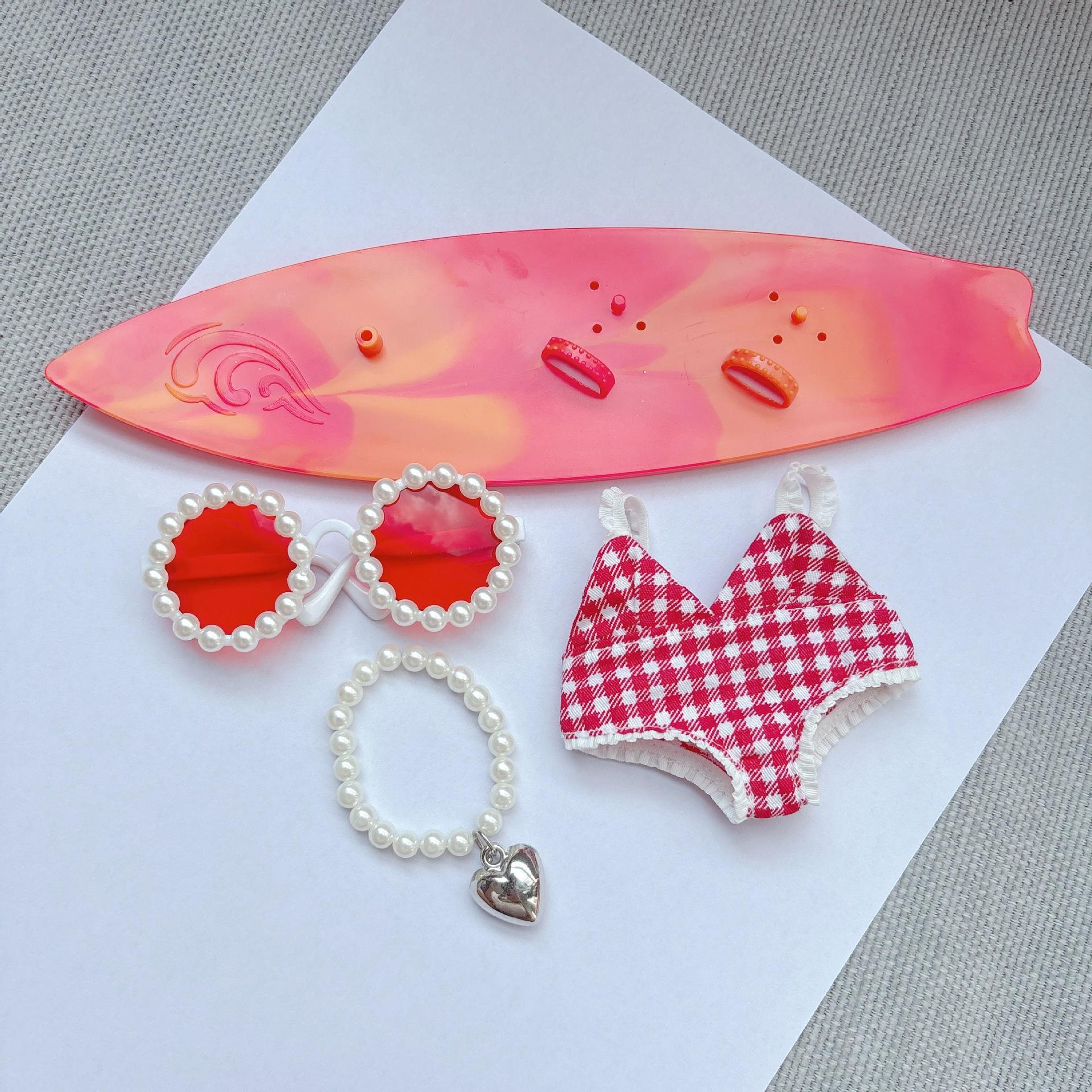 Red swimsuit red surfboard necklace red glasses