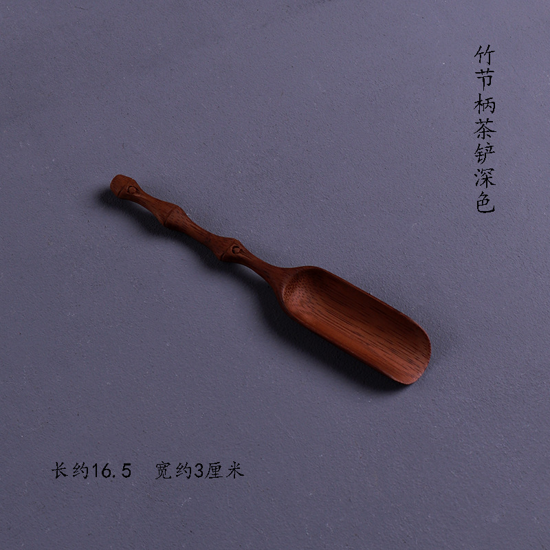 Dark-colored bamboo-handled tea spatula