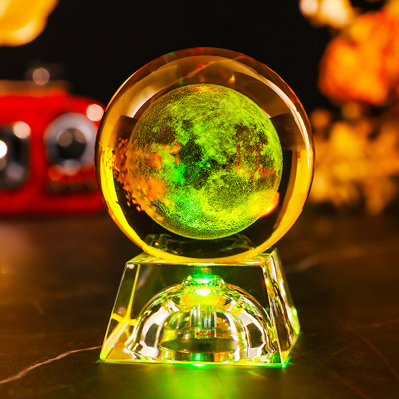 Base de cristal con luz de color del sistema solar.