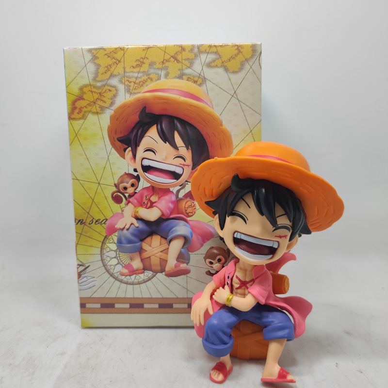 Sitting and smiling Luffy in a pink dress