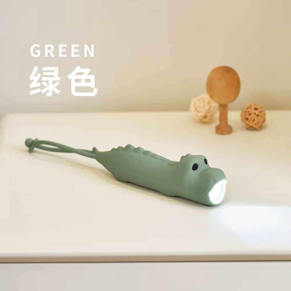 Lampe de poche en silicone dinosaure vert