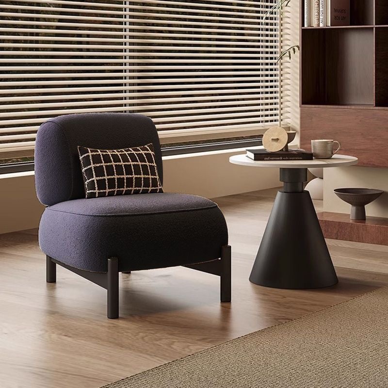 Fauteuil individuel bleu marine en laine d'agneau avec coussin.