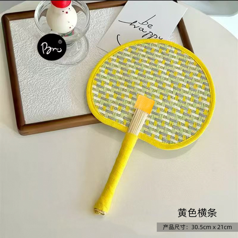 Yellow woven palm leaf fan