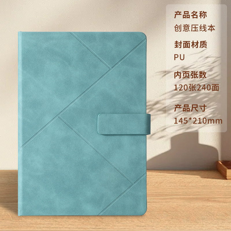Libro con hebilla prensada azul verdoso.