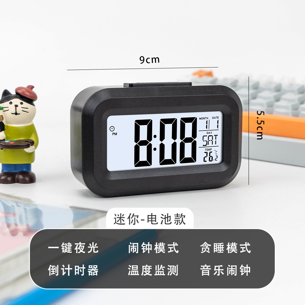 Reloj despertador multifuncional negro que brilla en la oscuridad