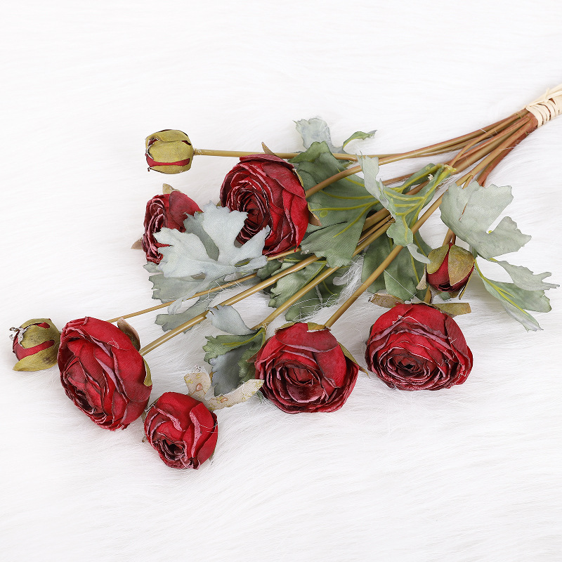Dewdrops adorn the bundle of autumn red.