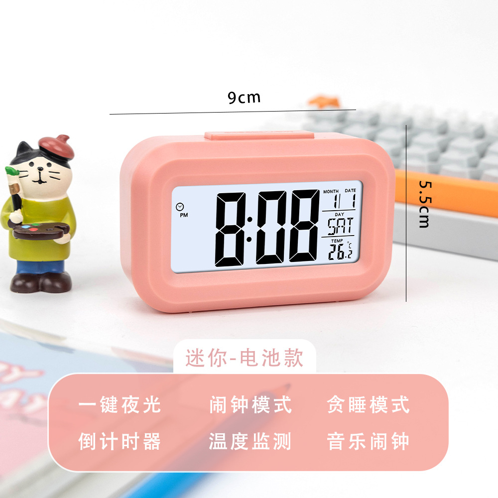 Reloj despertador multifuncional rosa que brilla en la oscuridad