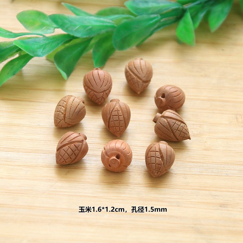 Peach wood corn pendant