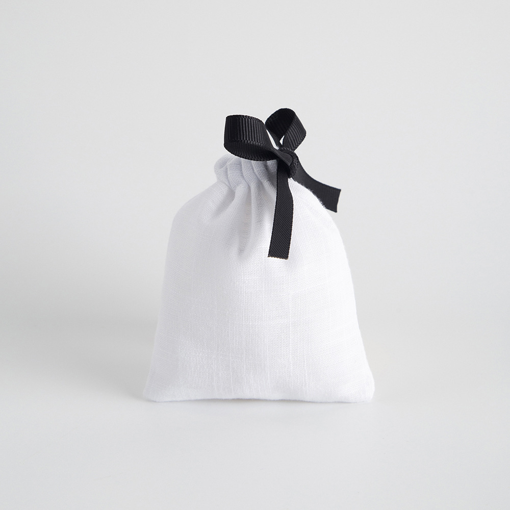 White bamboo-joint cotton with black ribbed tape on one side.