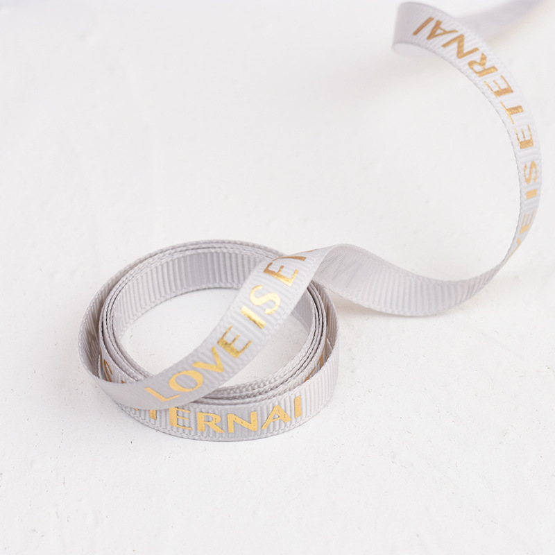 One meter of gold-stamped gray ribbon