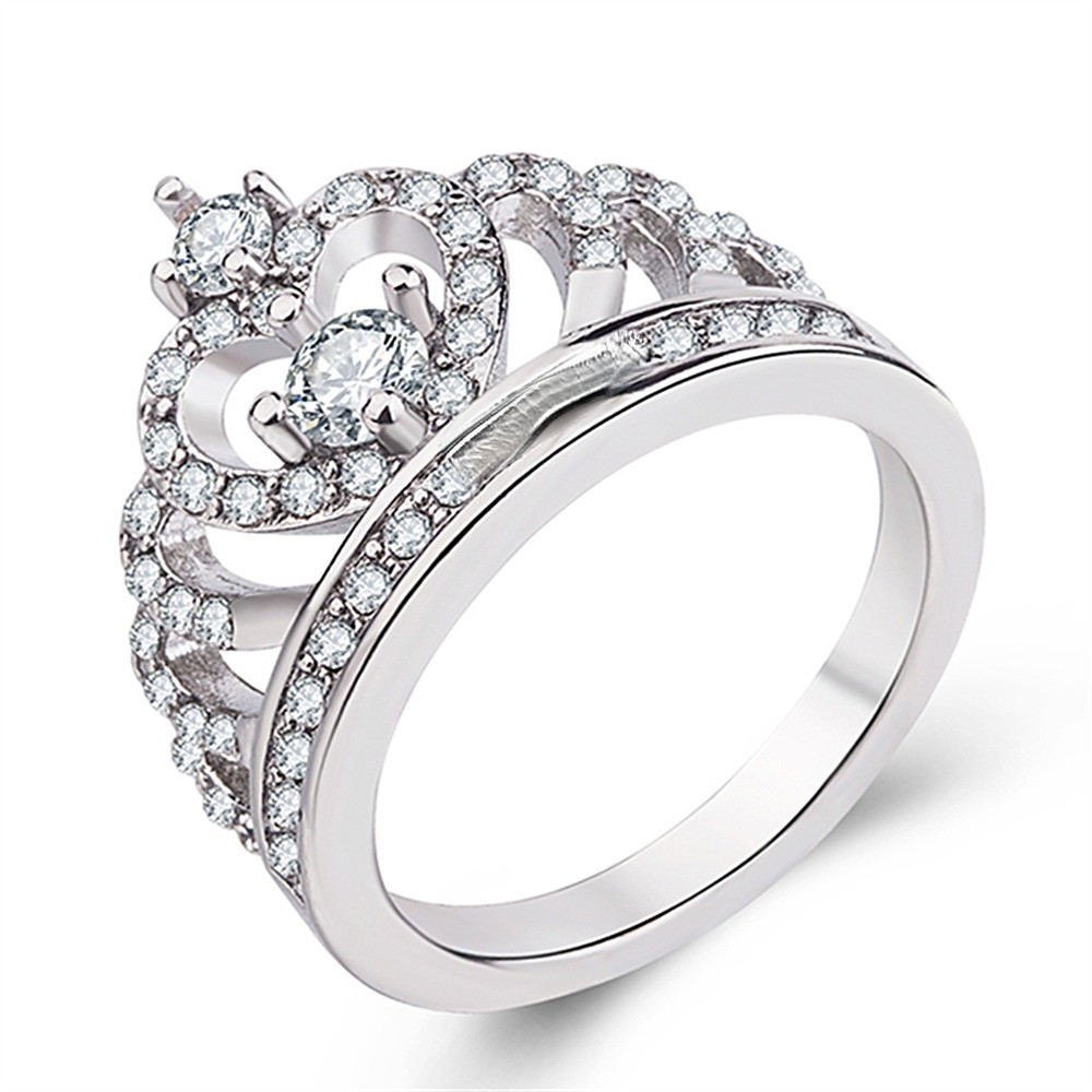A large white and gold crown ring