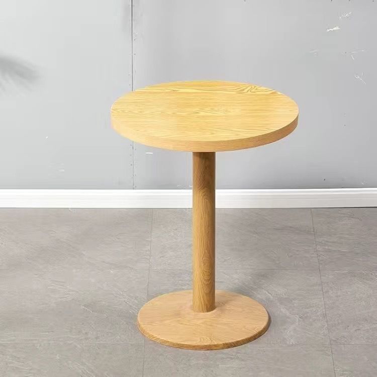 A set of round tables with natural wood pillars