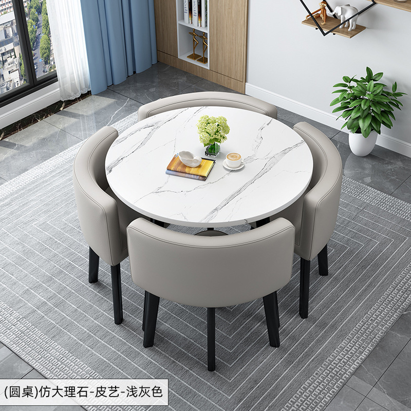 Tavolo rotondo decorato + sedia in pelle grigio chiaro