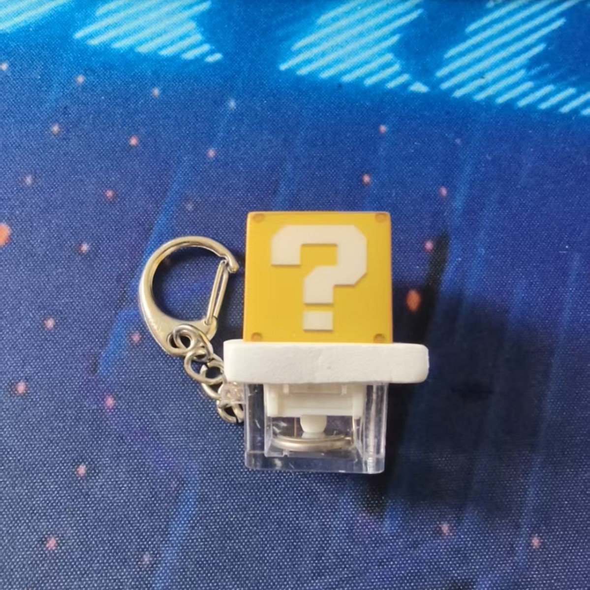 Question mark-illuminated button with transparent base